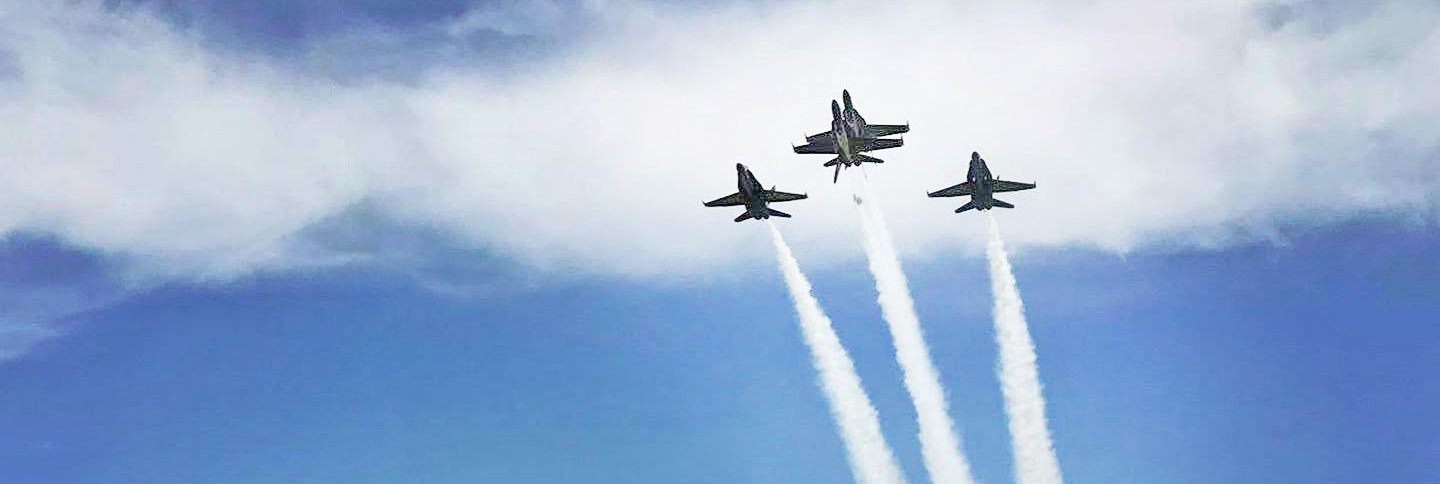 Blue Angels flying trail in clouds